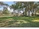 Charming yellow home with lush green lawn and mature trees, a peaceful suburban haven at 848 Hawk Lndg, Fruitland Park, FL 34731