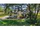 Lovely home exterior with manicured lawn, mature trees, and tasteful landscaping at 848 Hawk Lndg, Fruitland Park, FL 34731