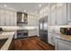 Modern kitchen featuring custom cabinets, stainless steel appliances, and hardwood floors at 848 Hawk Lndg, Fruitland Park, FL 34731