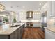 Bright kitchen with granite countertops, stainless steel appliances, and designer lighting fixtures at 848 Hawk Lndg, Fruitland Park, FL 34731