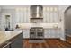 Gourmet kitchen features stainless steel appliances, white cabinetry and hardwood floors at 848 Hawk Lndg, Fruitland Park, FL 34731