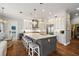 Spacious kitchen with a large island, pendant lighting, modern appliances, and ample storage at 848 Hawk Lndg, Fruitland Park, FL 34731
