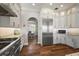 Well-lit kitchen offers stainless steel appliances, stylish cabinetry and hardwood floors at 848 Hawk Lndg, Fruitland Park, FL 34731