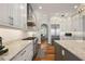 Gourmet kitchen with stainless steel appliances, granite countertops, and custom white cabinetry at 848 Hawk Lndg, Fruitland Park, FL 34731