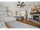Open concept living room connected to modern kitchen with island seating and fireplace at 848 Hawk Lndg, Fruitland Park, FL 34731