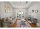 Bright living room with hardwood floors, plush seating, and views of the lake at 848 Hawk Lndg, Fruitland Park, FL 34731