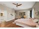 Serene main bedroom featuring stylish decor, hardwood floors, and a bright, airy ambiance at 848 Hawk Lndg, Fruitland Park, FL 34731