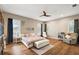 Spacious main bedroom with hardwood floors, ceiling fan, and lots of natural light at 848 Hawk Lndg, Fruitland Park, FL 34731