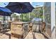 Built-in outdoor kitchen with a grill and wine cooler, perfect for entertaining at 848 Hawk Lndg, Fruitland Park, FL 34731
