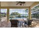 Outdoor patio with seating overlooking a pool, spa, and serene lake view at 848 Hawk Lndg, Fruitland Park, FL 34731