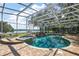 Stunning screened-in pool area with a spa and serene waterfront views at 848 Hawk Lndg, Fruitland Park, FL 34731