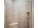 Shower with beige tiling, built in seat, and hand shower at 848 Hawk Lndg, Fruitland Park, FL 34731