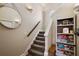 Carpeted stairway with a decorative shelving unit, ideal for storage and decor at 848 Hawk Lndg, Fruitland Park, FL 34731