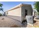 Exterior shot of home featuring a backyard, vinyl siding, and air conditioning unit at 9325 Se 172Nd Garden St, The Villages, FL 32162
