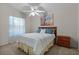 Comfortable bedroom featuring a ceiling fan and a decorative painting over the headboard at 9325 Se 172Nd Garden St, The Villages, FL 32162