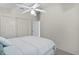 Bright bedroom with a ceiling fan, carpeted floors, and a double door closet for ample storage at 9325 Se 172Nd Garden St, The Villages, FL 32162