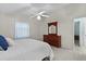 Bedroom with a ceiling fan, a large bed, dresser and wood furnishings at 9325 Se 172Nd Garden St, The Villages, FL 32162