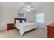 Bedroom with a ceiling fan, a large bed and wood furnishings at 9325 Se 172Nd Garden St, The Villages, FL 32162
