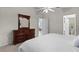 Bedroom with a light ceiling fan, a large bed and wood furnishings at 9325 Se 172Nd Garden St, The Villages, FL 32162
