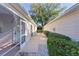 Exterior view showcasing a screened-in porch and landscaping separating the houses at 9325 Se 172Nd Garden St, The Villages, FL 32162