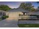 Charming home featuring a well-kept yard, a white picket fence, and a screened-in porch at 9325 Se 172Nd Garden St, The Villages, FL 32162