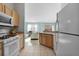 Kitchen with tile floor, wood cabinets, and stainless steel appliances at 9325 Se 172Nd Garden St, The Villages, FL 32162