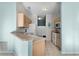 Cozy kitchen with wood cabinets, tile floor, and modern white appliances at 9325 Se 172Nd Garden St, The Villages, FL 32162