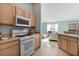 Kitchen with wood cabinets and stainless steel microwave at 9325 Se 172Nd Garden St, The Villages, FL 32162