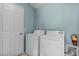 Functional laundry area with a washer, dryer, and ample space for sorting and folding clothes at 9325 Se 172Nd Garden St, The Villages, FL 32162