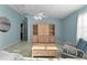 Comfortable living room with stylish furnishings, built-in shelving unit, and neutral-toned tile flooring at 9325 Se 172Nd Garden St, The Villages, FL 32162