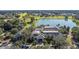 Stunning aerial view of the community clubhouse, pool, and lake offering scenic views and recreational activities at 9593 Se 124Th Loop, Summerfield, FL 34491