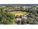 Aerial view showcasing a baseball field, memorial park, and lush green surroundings, perfect for recreational activities at 9593 Se 124Th Loop, Summerfield, FL 34491