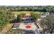 Aerial view showcases the baseball field, memorial park, and surrounding trees, creating a recreational space at 9593 Se 124Th Loop, Summerfield, FL 34491