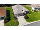 Inviting home with a manicured lawn, mature landscaping, a driveway, and an attached garage at 9593 Se 124Th Loop, Summerfield, FL 34491