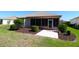 Well-maintained backyard featuring a screened-in porch and neatly landscaped shrubbery at 9593 Se 124Th Loop, Summerfield, FL 34491