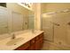 Bathroom featuring a double sink vanity and a glass enclosed shower at 9593 Se 124Th Loop, Summerfield, FL 34491