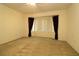 Bedroom featuring neutral carpet, ceiling fan and window at 9593 Se 124Th Loop, Summerfield, FL 34491