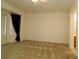 Bedroom featuring neutral carpet, ceiling fan and window at 9593 Se 124Th Loop, Summerfield, FL 34491