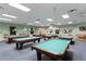 Well-lit billiard room features multiple tables, ideal for recreation and socializing within the community at 9593 Se 124Th Loop, Summerfield, FL 34491