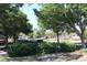 Community entrance with lush greenery and mature trees, offering a welcoming view at 9593 Se 124Th Loop, Summerfield, FL 34491