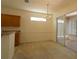 Bright dining area with chandelier and sliding doors to the lanai at 9593 Se 124Th Loop, Summerfield, FL 34491