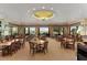 Bright, spacious dining room featuring many tables and chairs, perfect for enjoying meals with community members at 9593 Se 124Th Loop, Summerfield, FL 34491