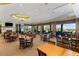 Inviting dining room features ample seating, large windows with scenic views, and a cozy fireplace at 9593 Se 124Th Loop, Summerfield, FL 34491