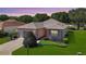 Charming single-story home featuring a well-manicured lawn and a two car garage at 9593 Se 124Th Loop, Summerfield, FL 34491