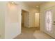 Open foyer showcasing carpet and tile flooring and an ornate decorative glass front door at 9593 Se 124Th Loop, Summerfield, FL 34491