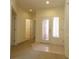 Bright foyer with carpet and tile flooring, decorative glass front door and recessed lighting at 9593 Se 124Th Loop, Summerfield, FL 34491