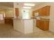 Open kitchen featuring wood cabinets, granite countertops and tile backsplash at 9593 Se 124Th Loop, Summerfield, FL 34491