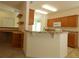 Bright kitchen featuring wooden cabinets and breakfast bar at 9593 Se 124Th Loop, Summerfield, FL 34491