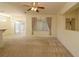 Cozy living room featuring carpet, a ceiling fan, and sliding glass doors to the lanai at 9593 Se 124Th Loop, Summerfield, FL 34491