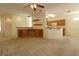 Open-concept living room with ceiling fan, seamlessly flowing into the adjacent kitchen at 9593 Se 124Th Loop, Summerfield, FL 34491